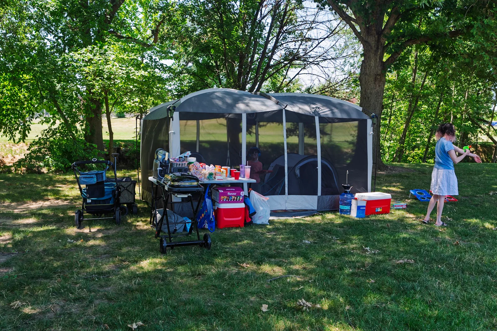 Our screen tent and gear set up in the shade of the trees by the river
