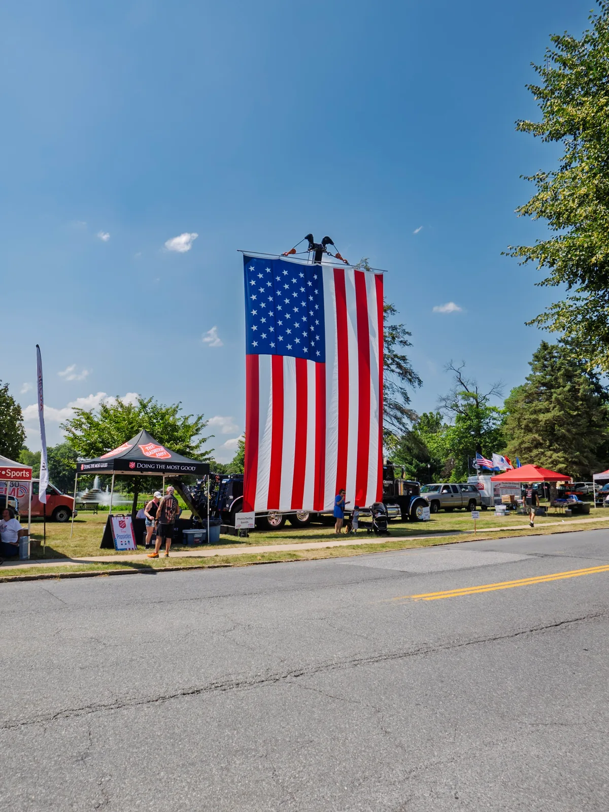 A giant American flag hanging over the street