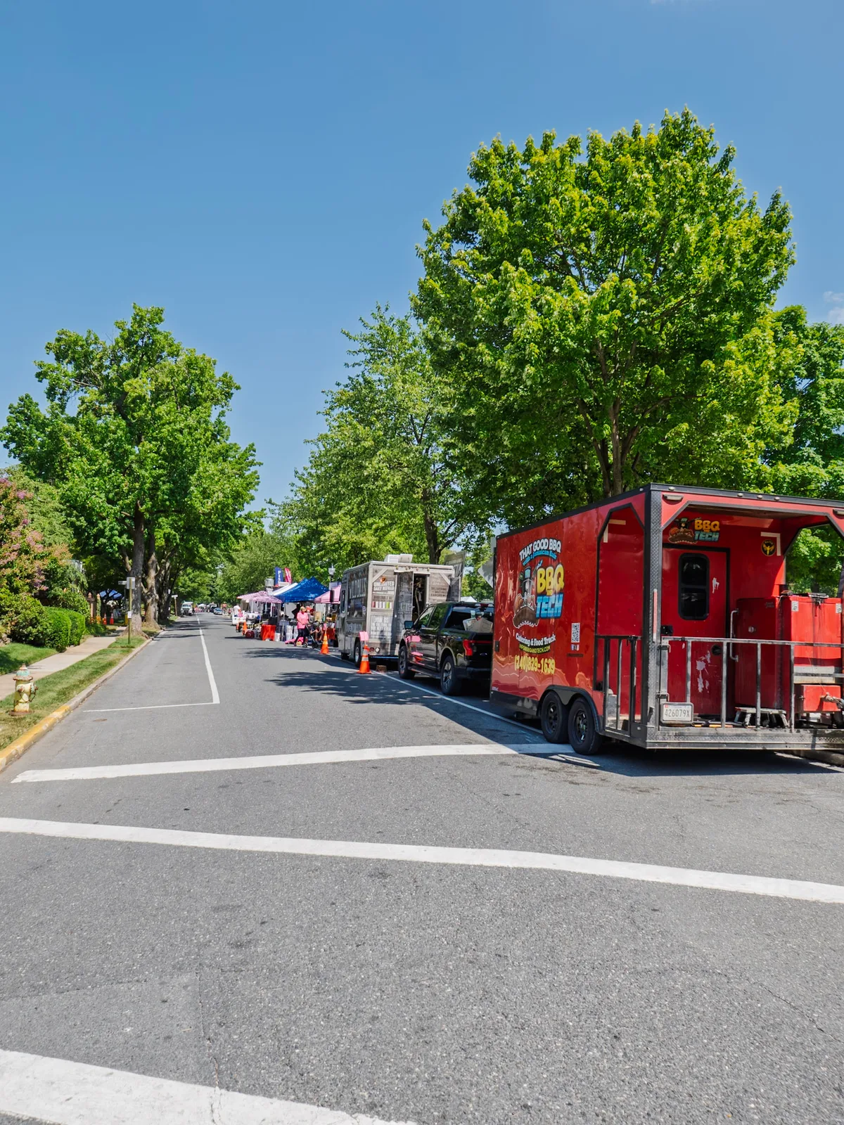 A row of food trucks lined up along the festival street