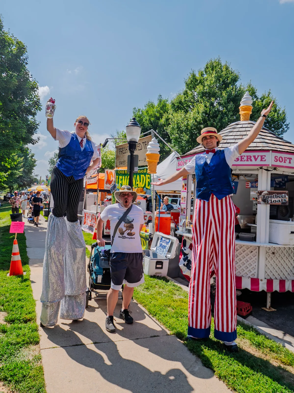 Patriotic Uncle Sam performers by a lemonade cart