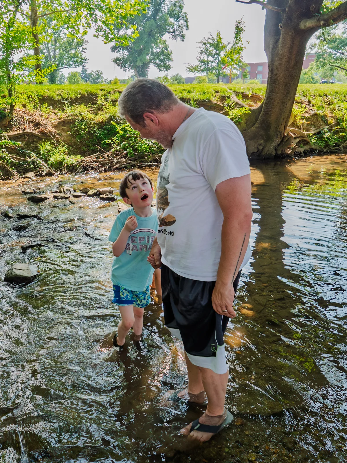 Ray helping Cody wade into the cool creek