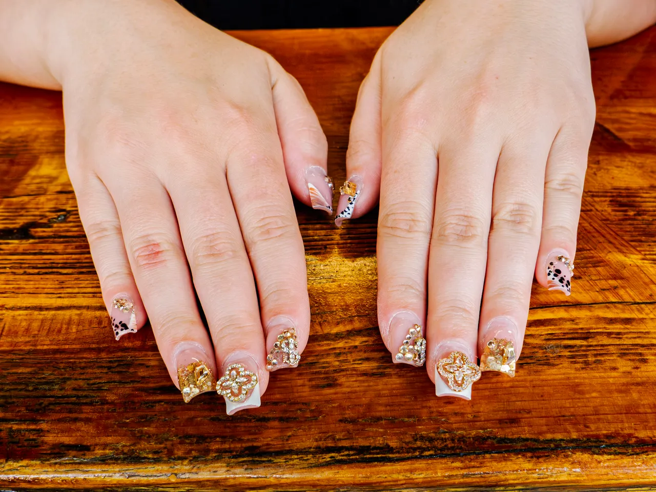 Festival-ready manicure with gold and gem details