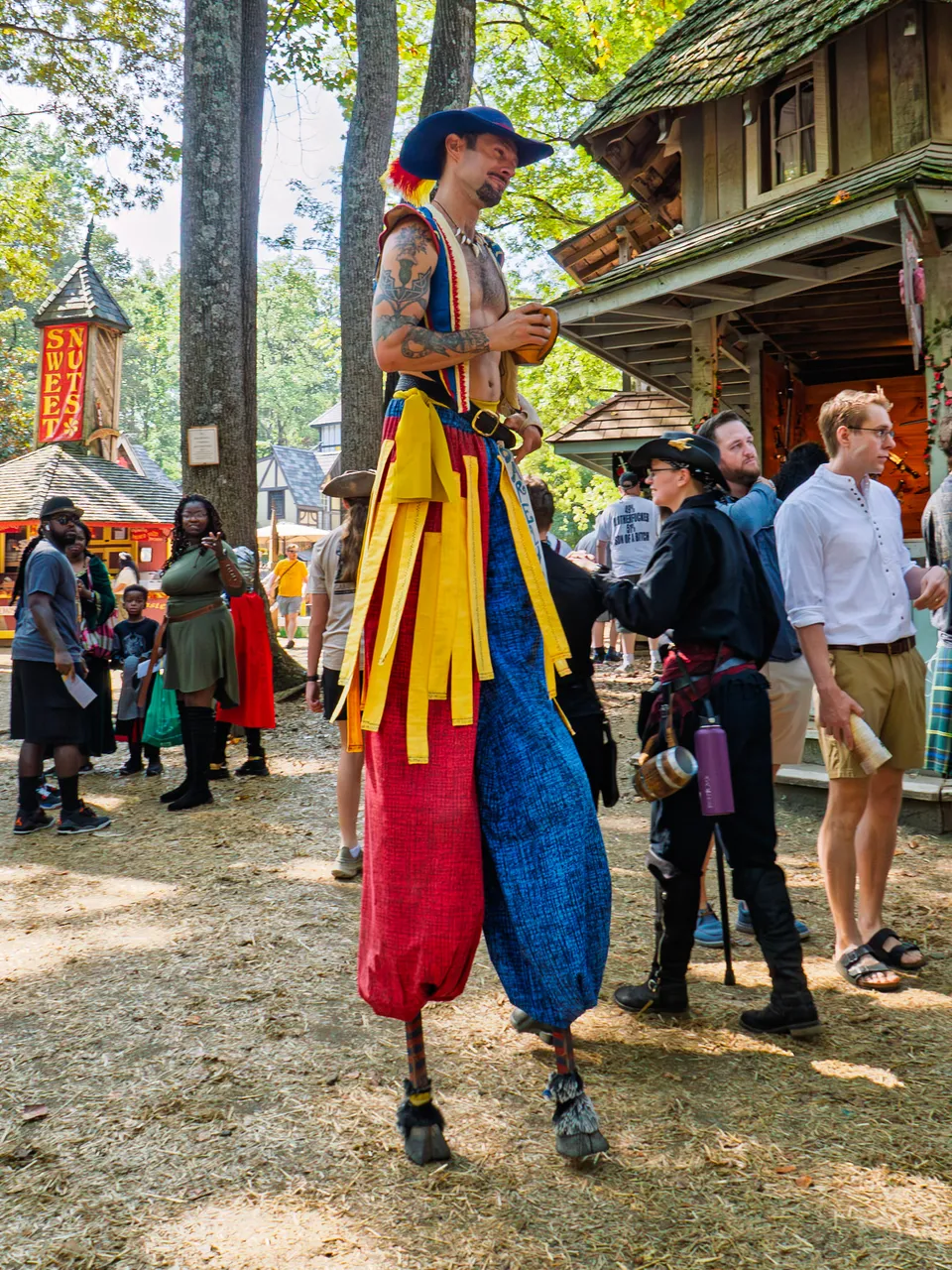 A stilt walker towering over the festival crowd