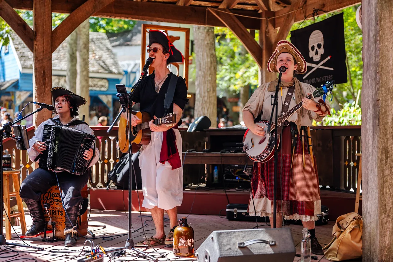 A pirate band performing under the jolly roger
